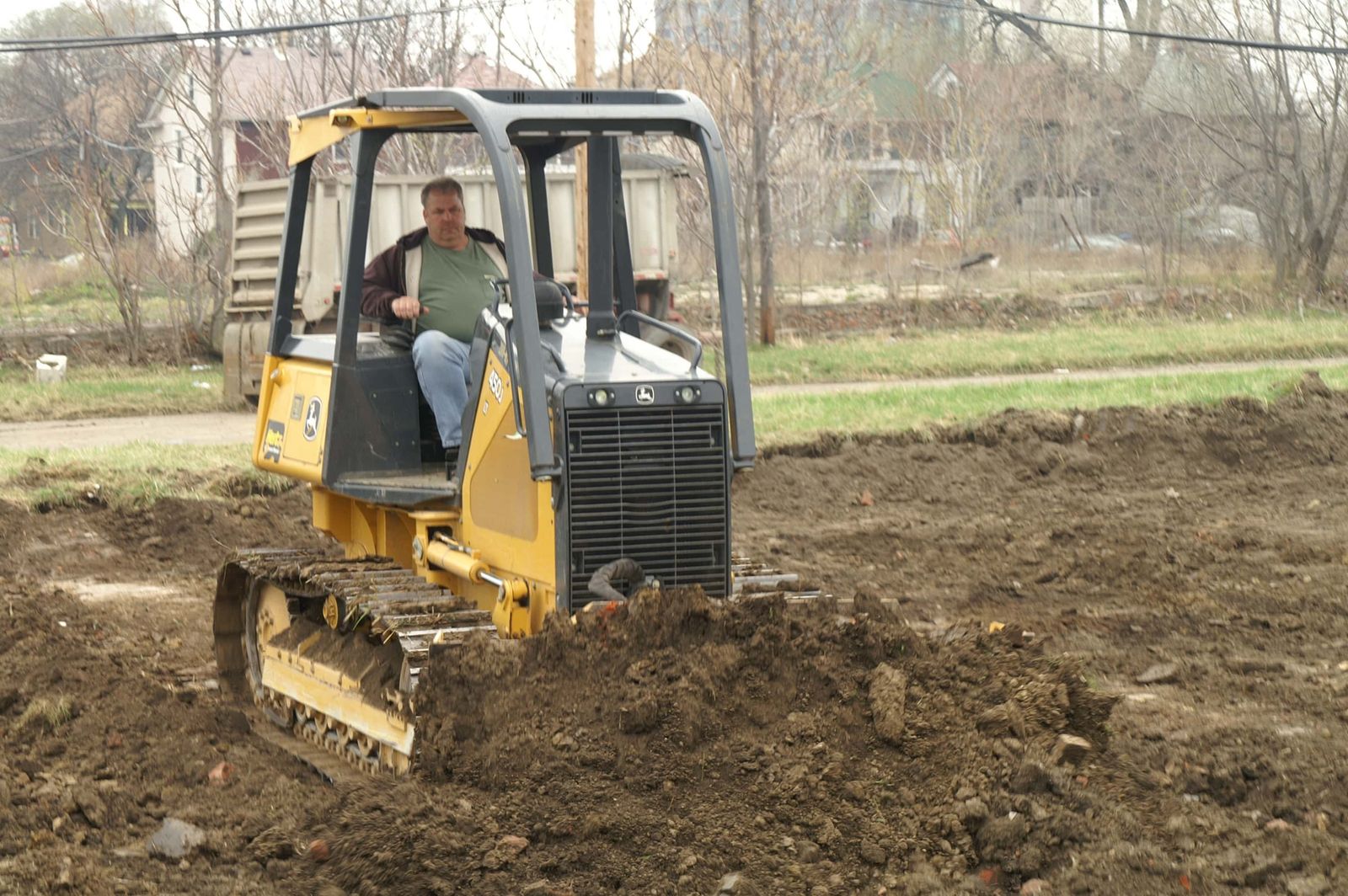 Operator grading a building pad with a crawler dozer