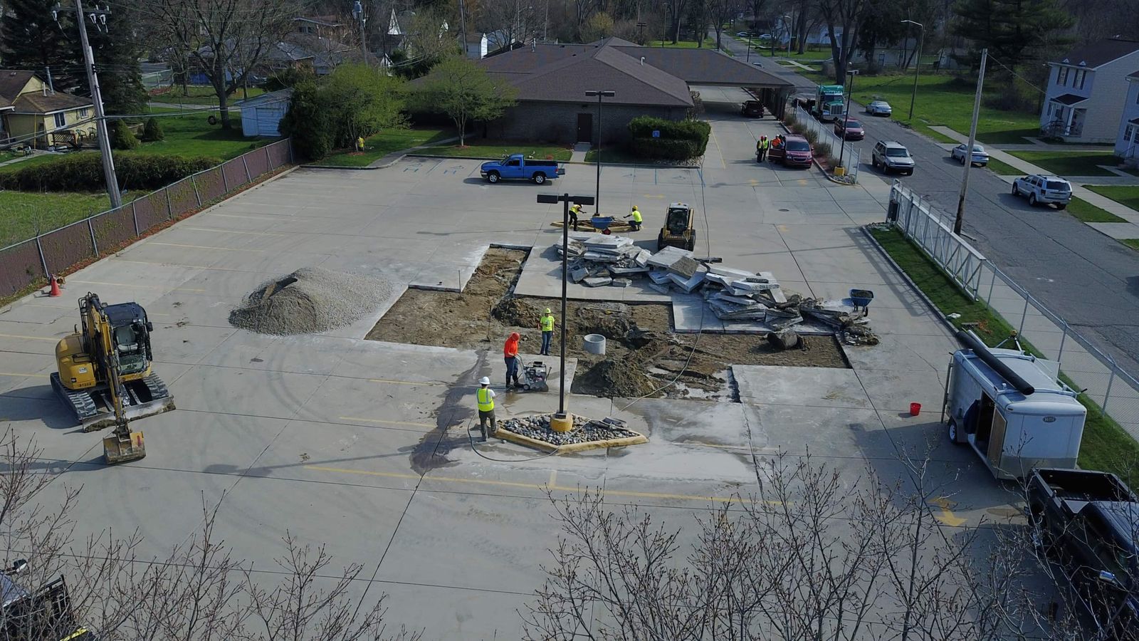 Aerial view of site work and concrete replacement in a commercial parking lot