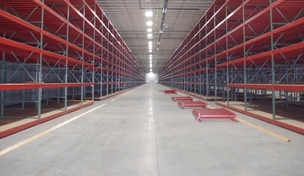 Long aisle of newly installed selective pallet racking in a distribution warehouse